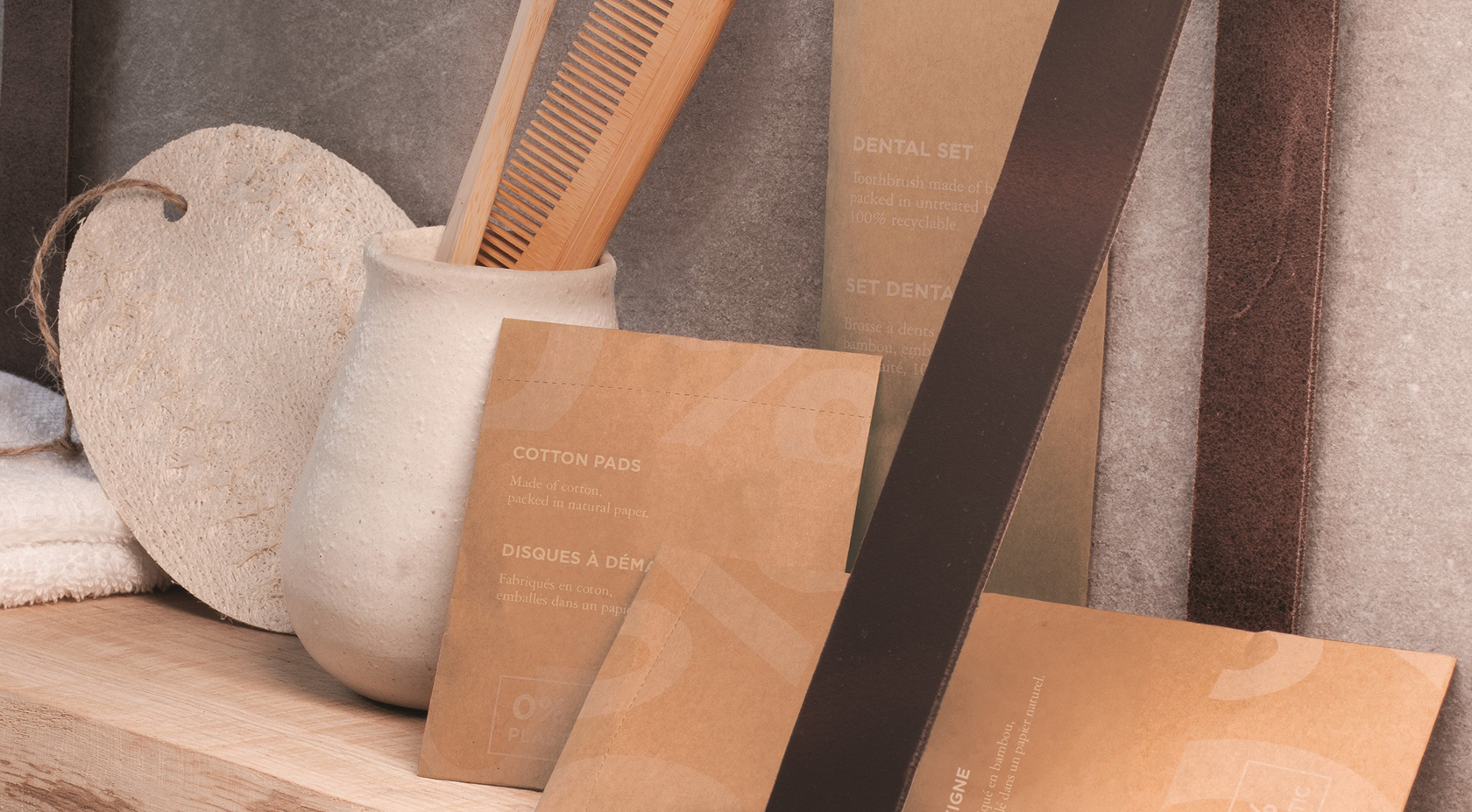 A minimalist shelf displaying a textured ceramic vase, wooden comb, and eco-friendly packaging for dental and cotton products against a neutral backdrop.