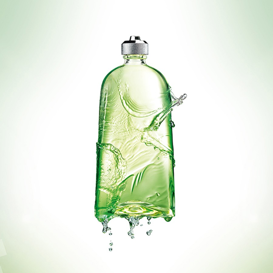 A green plastic bottle with liquid splashing out, set against a light background. The bottle has a silver cap and appears to be in motion.