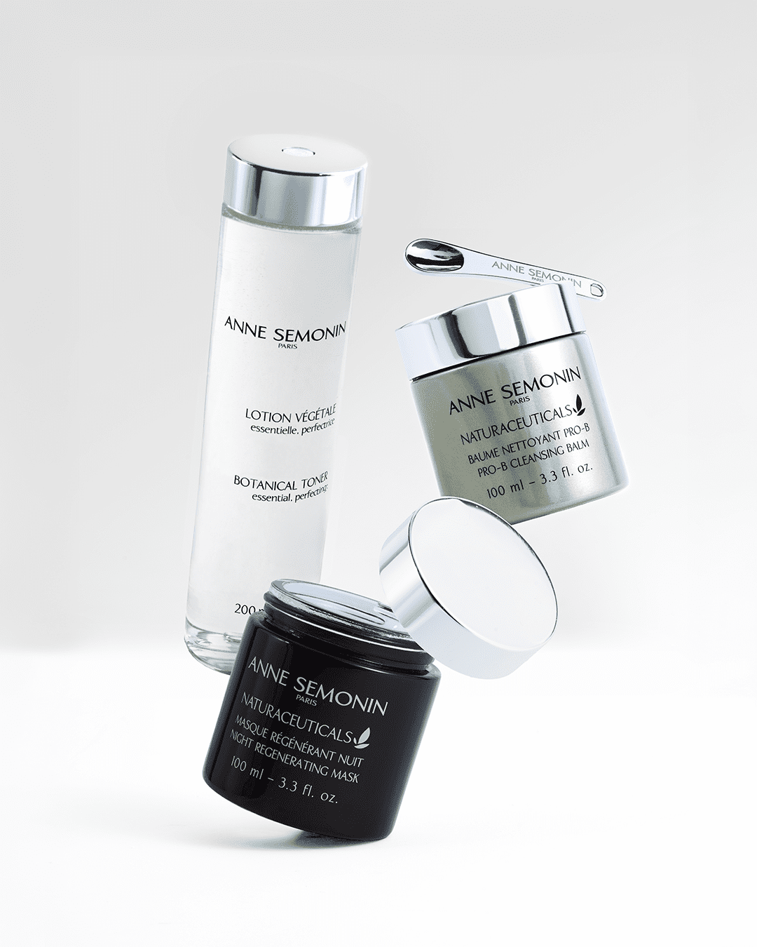 Three skincare products from Anne Semonin, including a lotion, a balm, and a mask, presented against a light background. The packaging features elegant and minimalist designs, emphasizing luxury and skincare.