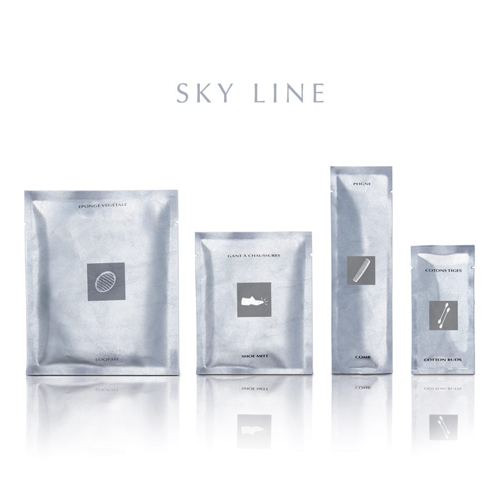 A collection of four silver packaging items labeled with simple icons, arranged on a reflective surface with the text "SKY LINE" above.