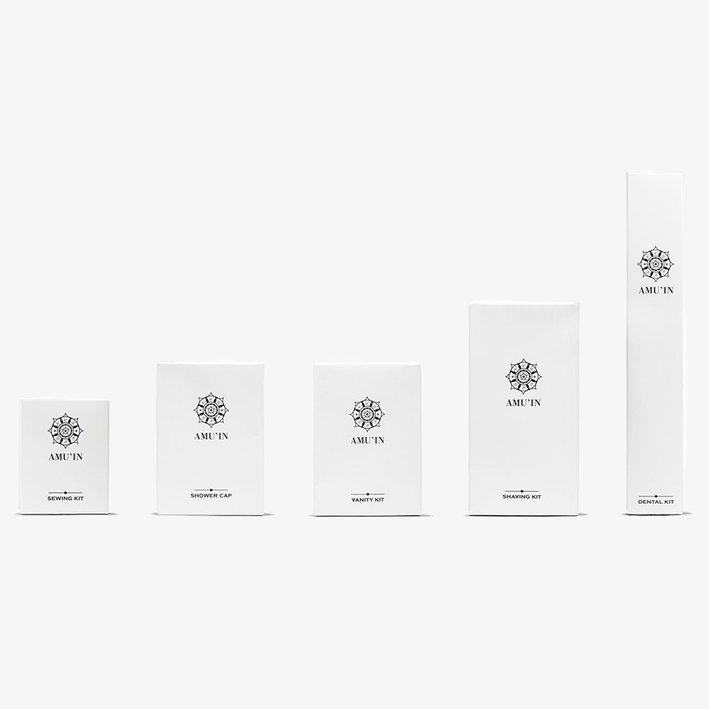 A set of five white boxes with minimalist designs, each labeled with the brand name "AMUT'IN" and indicating different products like "Shaving Kit," "Vanity Kit," and "Shower Cap." The boxes are arranged in a gradient from smallest to largest.
