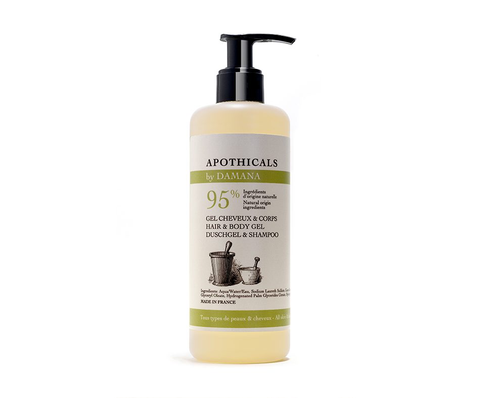 A translucent bottle of hair and body gel with a pump top, labeled "Apothicals by Damana," indicating 95% natural ingredients and made in France. The label features an illustration of tools used in herbal preparation.