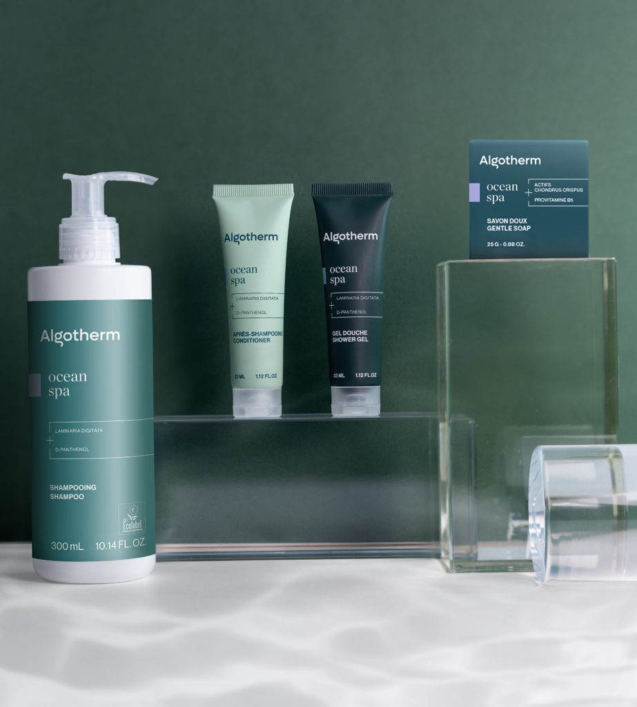 Product display featuring Algotherm Ocean Spa skincare items, including a shampoo bottle and two tubes of gel, against a soft green background.