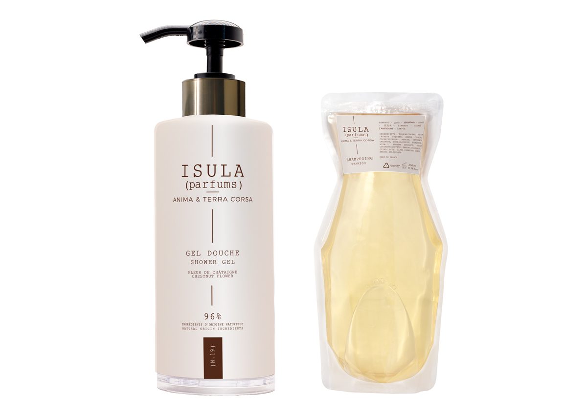 A bottle of Isula shower gel with a pump dispenser and a matching refill pouch beside it. Both items feature a minimalist design with a white and beige color scheme.