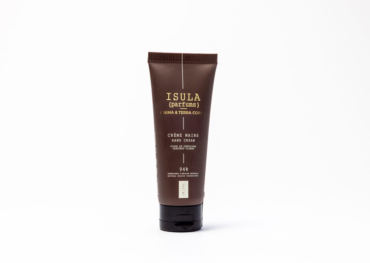 A brown tube of hand cream labeled "ISULA" with the text "Crème Mains" and a list of ingredients. The tube is set against a plain background.