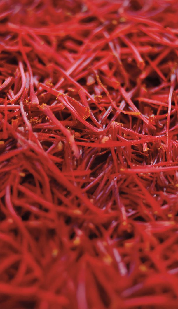 A close-up image of vibrant red saffron threads, showcasing their delicate and thin texture.