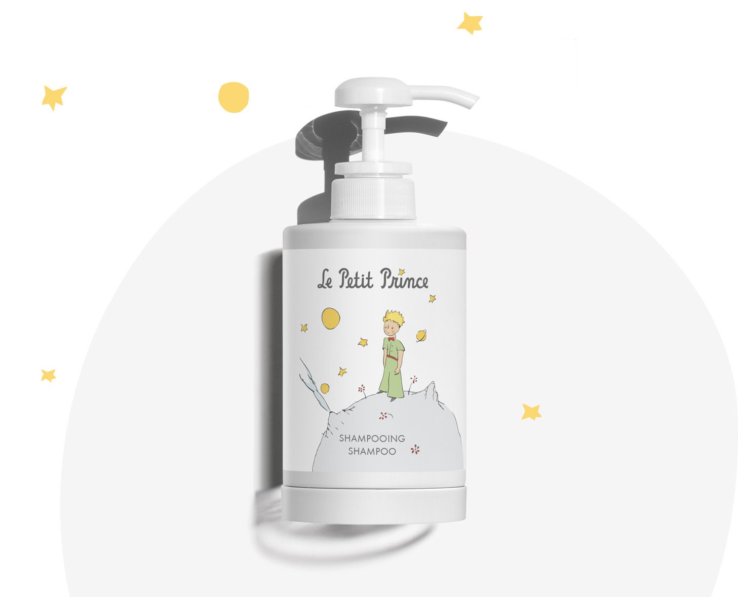 A bottle of shampoo featuring a whimsical illustration inspired by "Le Petit Prince," with a pump dispenser and decorative stars in the background.