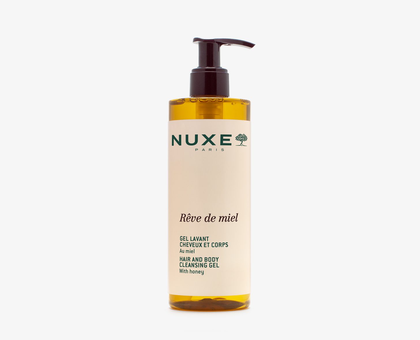 A bottle of NUXE Rêve de Miel hair and body cleansing gel, featuring a pump top and a honey-colored liquid. The label displays the brand name, product name, and description.