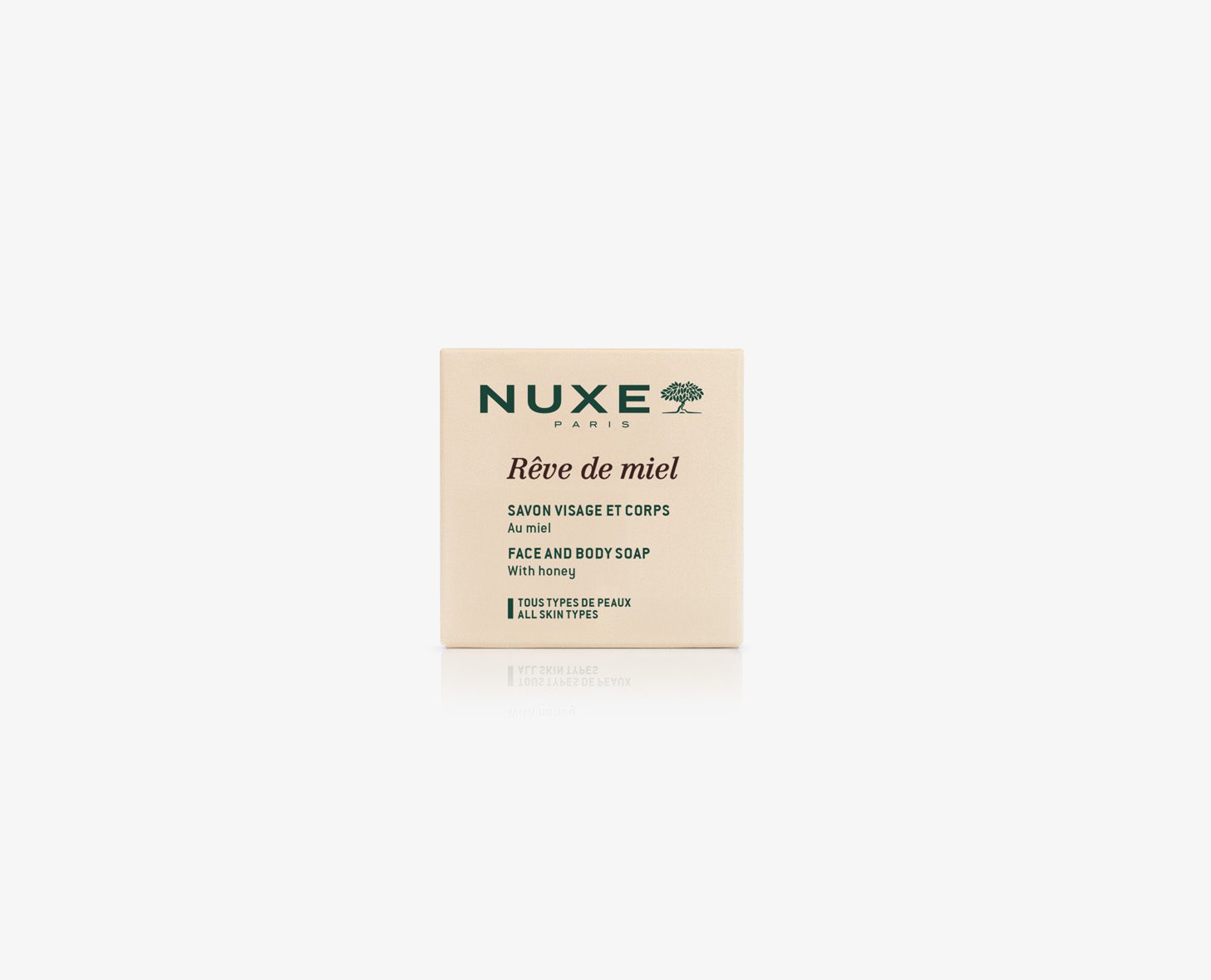 A beige box of NUXE Rêve de Miel face and body soap with honey, featuring green text and a tree logo.