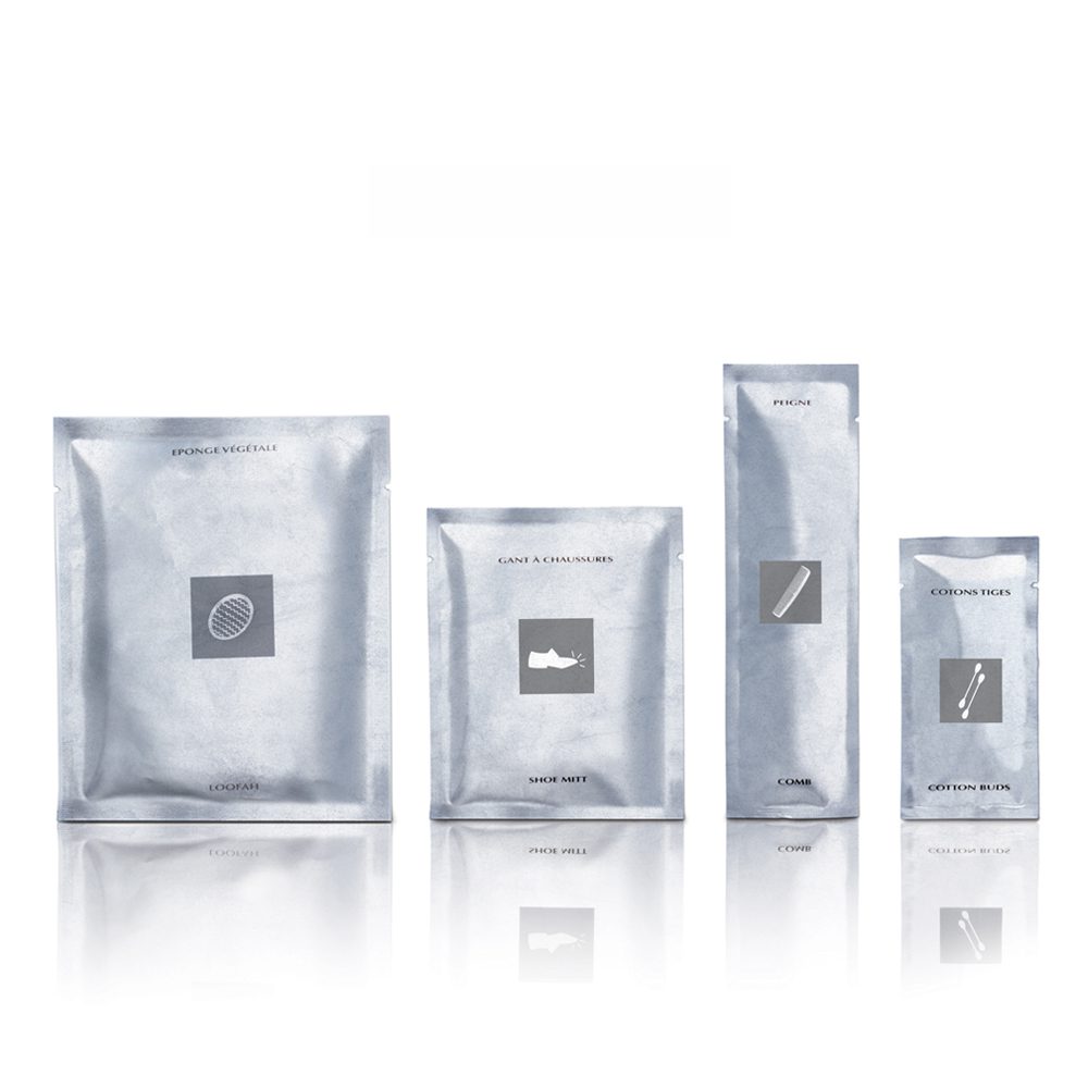 Four packages in silver, each labeled with a simple icon representing their contents: a sponge, a makeup sponge, a comb, and cotton swabs. The packages are arranged in a row against a white background.