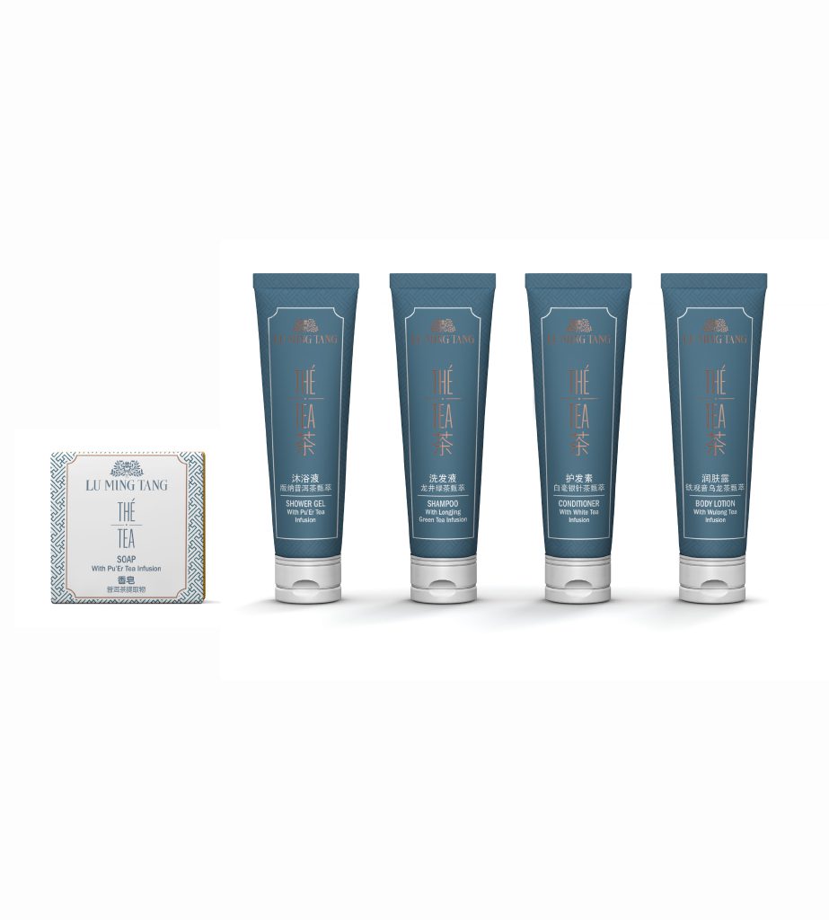 A collection of four blue tubes of skincare products alongside a small rectangular box of tea, all featuring decorative labels.