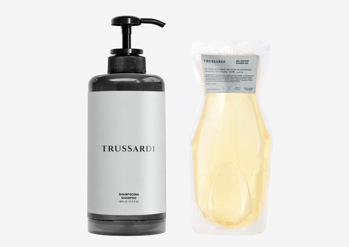 A black bottle of Trussardi shampoo with a pump and a resealable pouch containing additional shampoo. The bottle features a minimalist design with the brand name displayed prominently.