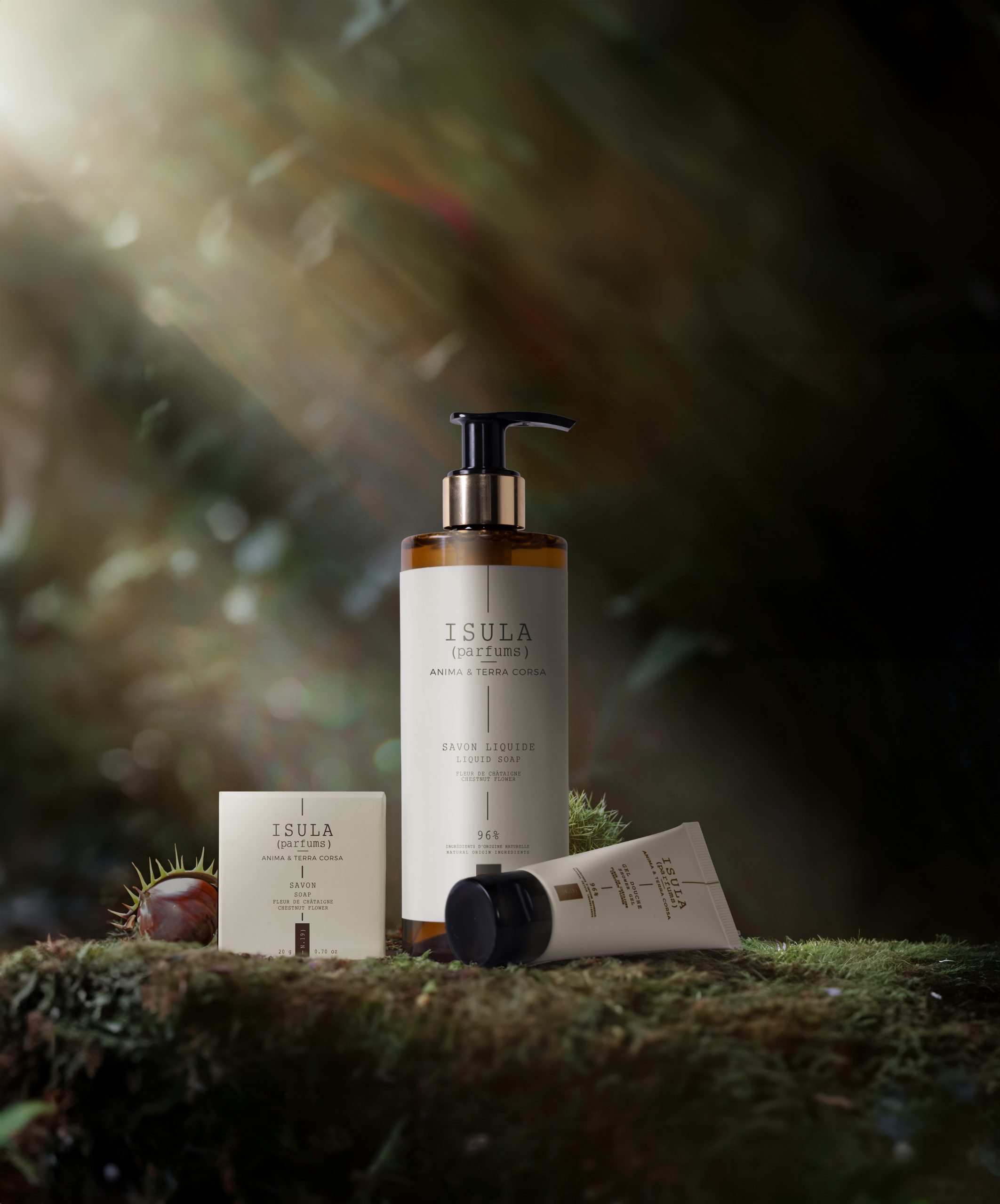 Isula Parfums liquid soap, soap bar and tube displayed on moss in a natural forest setting