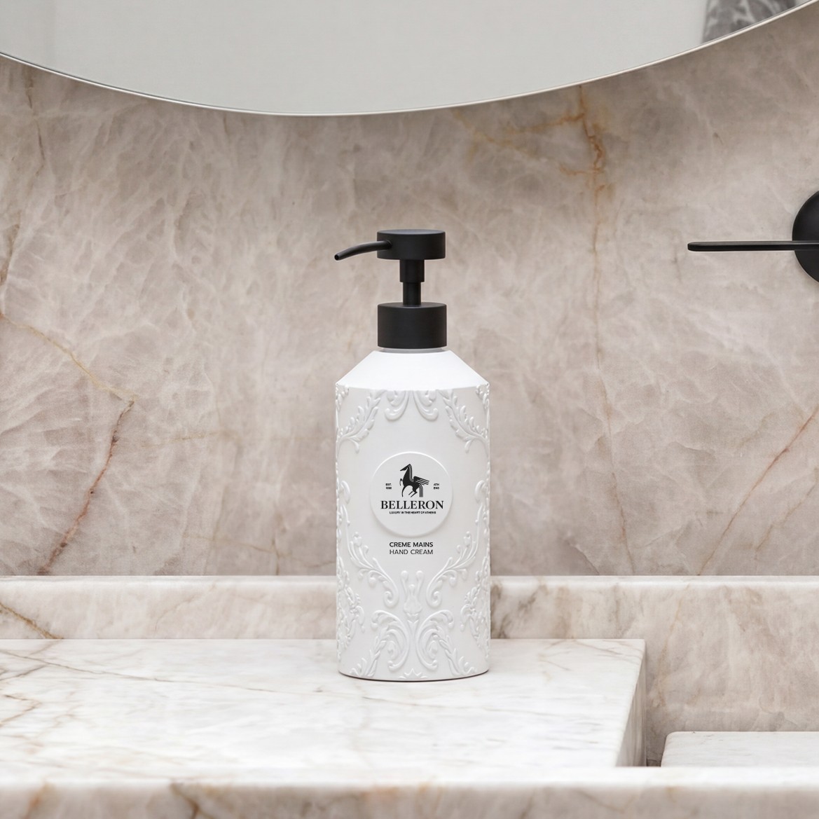 Elegant white “Belleron” hand cream bottle with black pump, featuring embossed decorative design, placed on a marble bathroom countertop with neutral stone wall background.