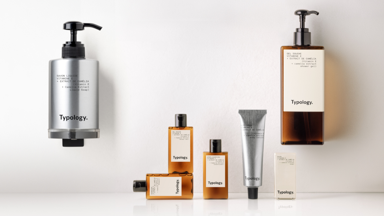 Typology skincare and haircare products displayed with wall-mounted dispensers