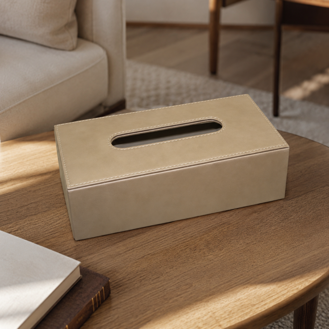 Leather-covered tissue box placed on a wooden coffee table in a lounge setting.