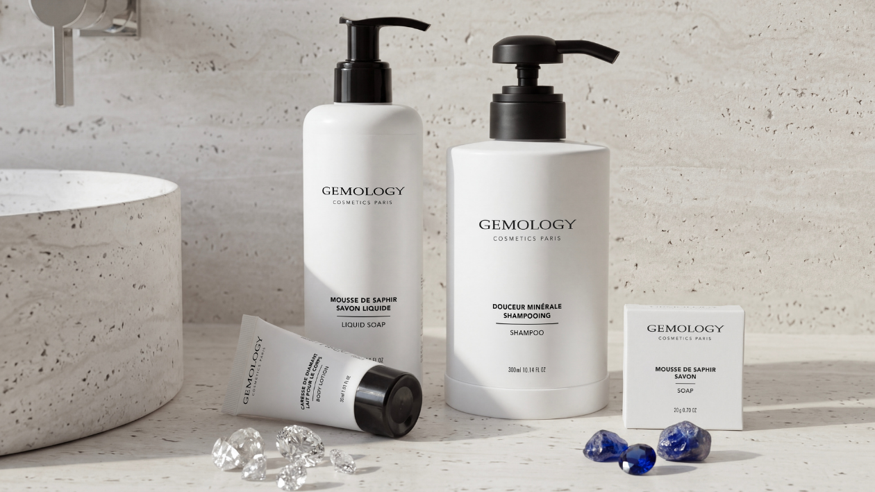 Copilot said: Gemology bathroom amenities, including liquid soap, shampoo, body lotion, and soap, displayed on a stone countertop with decorative gemstones in a minimalist bathroom setting.