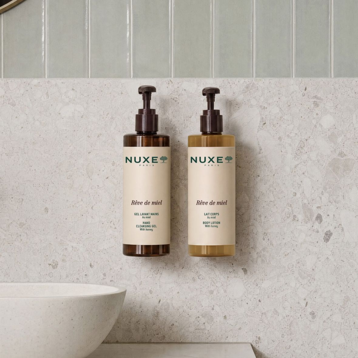 NUXE Rêve de Miel hand cleansing gel and body lotion displayed in a modern bathroom, honey-infused daily skincare products.