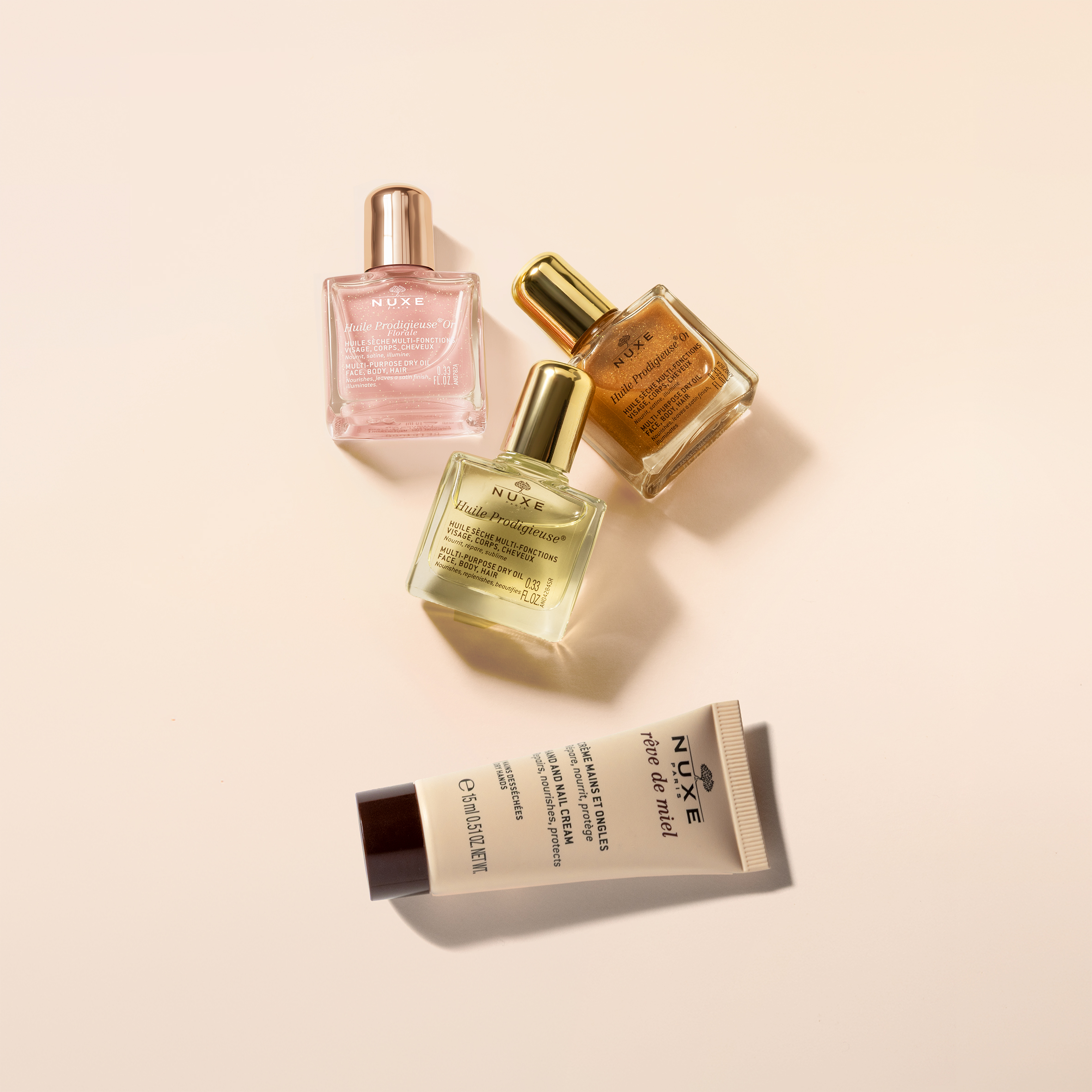 NUXE Huile Prodigieuse and Rêve de Miel skincare essentials, featuring multi-purpose dry oils and nourishing hand cream for face, body and hair.